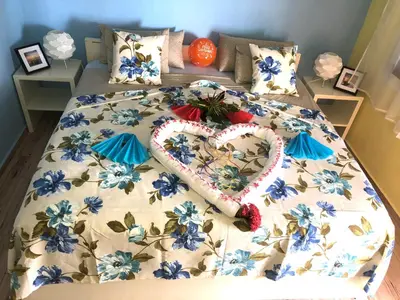 a bed with a heart made out of blue flowers at Casa Azul Las Galeras in Las Galeras