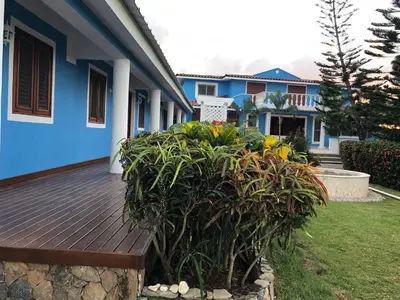 a wooden deck in front of a house at Casa Azul Las Galeras in Las Galeras