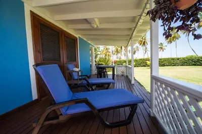 a porch with blue chairs on a house at Casa Azul Las Galeras in Las Galeras