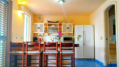 a kitchen with a refrigerator and a table and chairs at La Dolce Vita 12 Beachfront Hotels, Las Terrenas, Samana in Las Terrenas