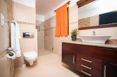a bathroom with a sink and a toilet at Cabarete Palm Beach Condos in Cabarete