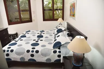 a bedroom with a bed with polka dot sheets and a lamp at Cabarete Palm Beach Condos in Cabarete