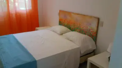 a bedroom with a bed with a painting on the wall at Villa Florencia Vip in Punta Cana