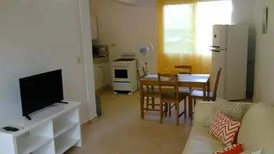 a living room with a couch and a kitchen with a table at Villa Florencia Vip in Punta Cana