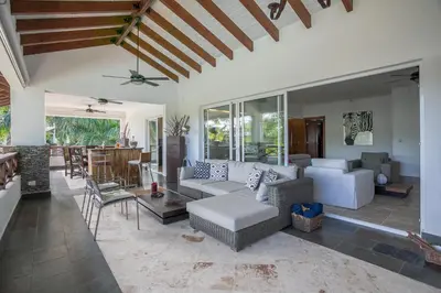 a living room with a couch and a table at Balcones Beach Penthouse in Las Terrenas