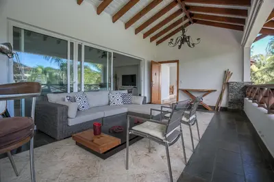 a living room with a couch and a table and chairs at Balcones Beach Penthouse in Las Terrenas