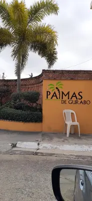 a white chair sitting on the side of a building at Residencial Palmas De Gurabo in Santiago de los Caballeros