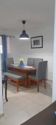 a dining room with a table and two chairs at Residencial Palmas De Gurabo in Santiago de los Caballeros