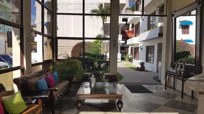 a lobby with couches and a table in a building at Sosua by the Sea in Sosúa