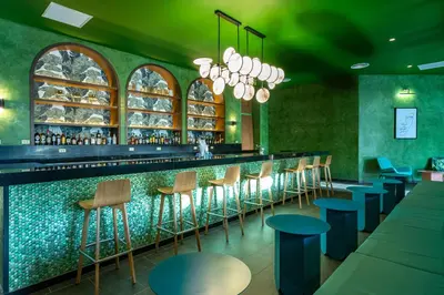 a bar with blue stools in a restaurant at Tropical Deluxe Princess - All Inclusive in Punta Cana