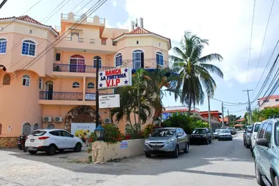 a street with cars parked in front of a building at Caribe Apartament S&D el castillo dominicus Apartamento #9 in Bayahibe