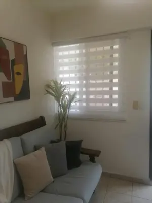 a living room with a couch and a window at J. B Apartamentos in Santo Domingo