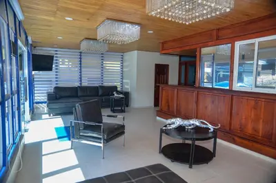 a living room with a couch and a table at Hotel Jaraba in Jarabacoa
