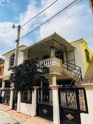 a white and yellow house with a balcony at Oasis de paz in Jarabacoa