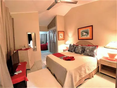 a bedroom with a bed with a red ribbon on it at Hotel Coco Plaza in Las Terrenas