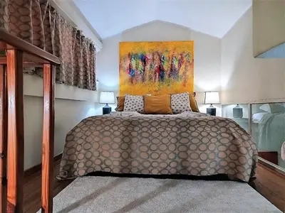 a bedroom with a bed with a painting on the wall at Hotel Coco Plaza in Las Terrenas