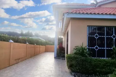 a house with a gate and a walkway at Elegant Villa in Nagua with Private Pool and Jacuzzi in Nagua