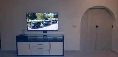 a flat screen tv on a wall next to a door at Villas for Vacation 32-18-6 in Sosúa
