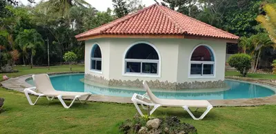 a gazebo with two lounge chairs next to a pool at Villas for Vacation 32-18-6 in Sosúa