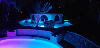 a night view of a house with blue lights at Villas for Vacation 32-18-6 in Sosúa