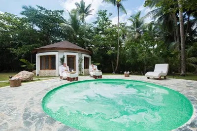 a pool in the middle of a patio with a house at Sublime Samana in Las Terrenas