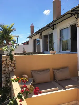a couch on the balcony of a house at Cabrera Chalet boutique hotel in Cabrera