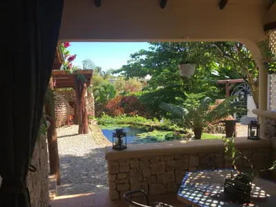 a view of a garden from the porch of a house at Cabrera Chalet boutique hotel in Cabrera