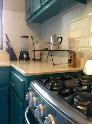 a kitchen with a stove and a blender on the counter at Lugo`s guest room in Punta Cana