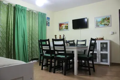 a dining room with a table and chairs and a television at Apartamento B6 El Dorado en Bávaro - Punta Cana in Punta Cana