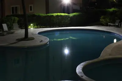 a swimming pool in a yard at night at Apartamento B6 El Dorado en Bávaro - Punta Cana in Punta Cana