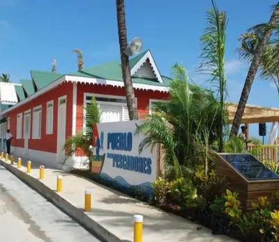 a red building with a sign in front of it at Villa Luce in Las Terrenas