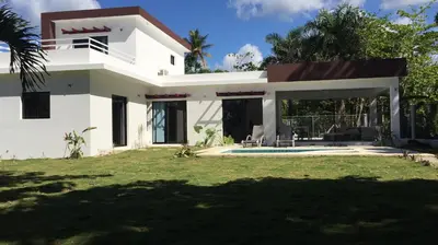 a large white house with a yard at Villa Luce in Las Terrenas