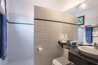 a bathroom with a toilet and a sink at Hotel Villa Colonial in Santo Domingo