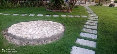 a garden with a stone path in the grass at Los Palmares Guest House & Eventos in San Cristóbal
