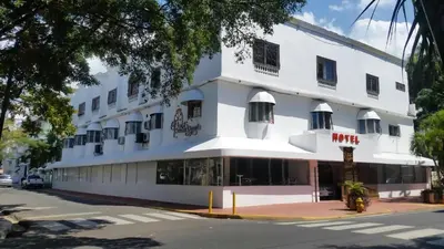 a white building with windows and a street at Hotel La Casona Dorada in Santo Domingo