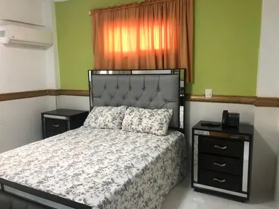 a bedroom with a bed and a window at Hotel La Casona Dorada in Santo Domingo