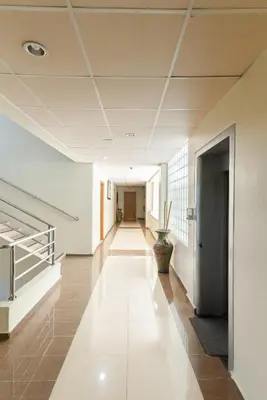 an empty hallway in a building with a plant at Aparta Hotel Roma in Santo Domingo