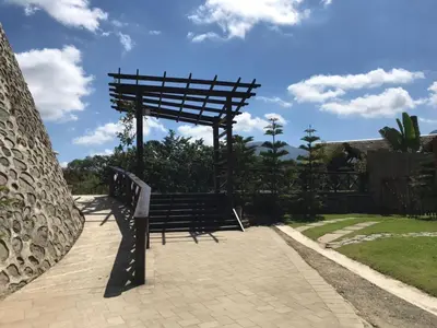 a wooden bench sitting on a brick walkway at Ximenoa Rivers Villa Relax in Jarabacoa