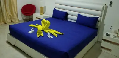 a yellow stuffed animal laying on top of a bed at Villa de Colores 3 Rooms 5 king Beds in Sosúa