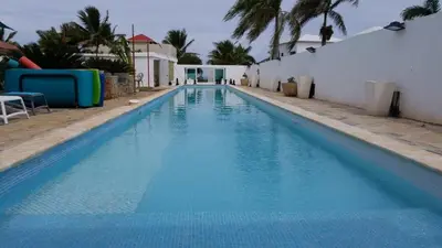 a swimming pool with blue water in a resort at Villa de Colores 3 Rooms 5 king Beds in Sosúa