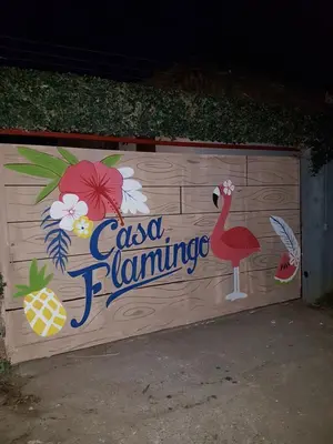a fence with a sign on it with a flamingo at Casa Flamingo in Las Terrenas