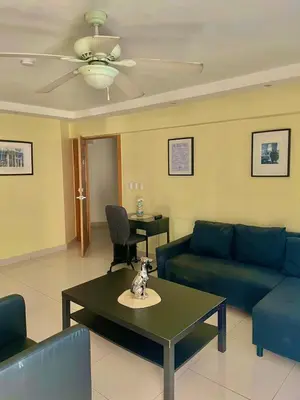 a living room with a couch and a table at City Caribbean Hotel Boutique in Santo Domingo