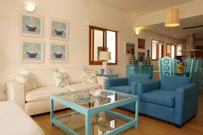 a living room with a couch and a table at Sybaris Suites & Residences in Juan Dolio