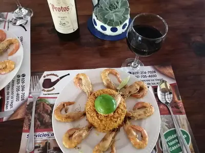 a plate of pretzels on a table with a glass of wine at La famosa costillas a la leña in Jarabacoa