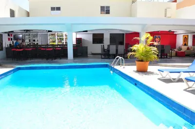 a swimming pool in the middle of a building at Hotel Las Palmeras in Sosúa