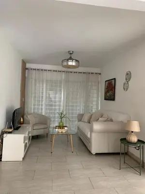 a living room with a couch and a table at Beautiful & Comfortable Apartment near Colonial Zone in Santo Domingo