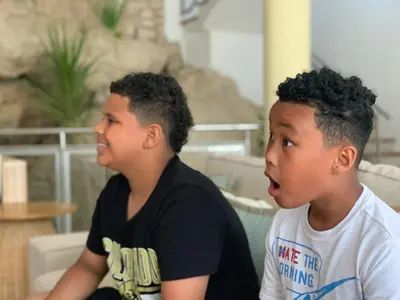 two young boys sitting next to each other at Casa Coral Sosua in Sosúa