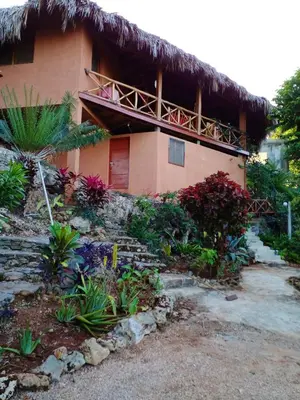 a house with a thatched roof and some plants at Welcoming House in Las Galeras with Stunning Sea View in Las Galeras