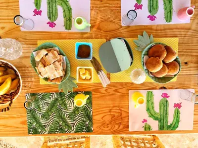 a table topped with plates of food and snacks at GuaiGüí Bayahibe in Bayahibe