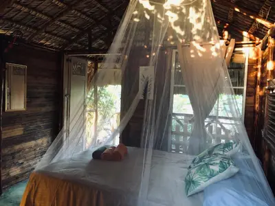 a canopy bed in a room with a window at GuaiGüí Bayahibe in Bayahibe